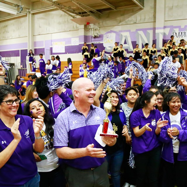 Teacher holding trophy